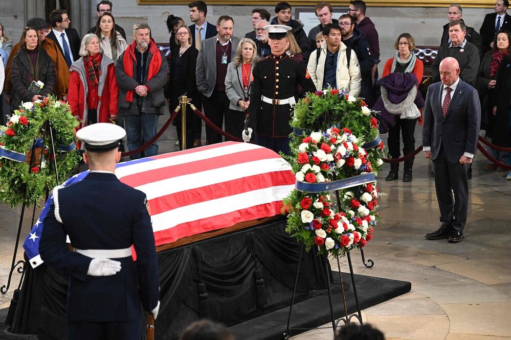 El senador estadounidense Mark Kelly presenta sus respetos ante el féretro envuelto en la bandera durante la ceremonia de entierro del expresidente Jimmy Carter en la rotonda del Capitolio de Estados Unidos en Washington, DC, el 8 de enero de 2025. FOTO: AFP/Archivo