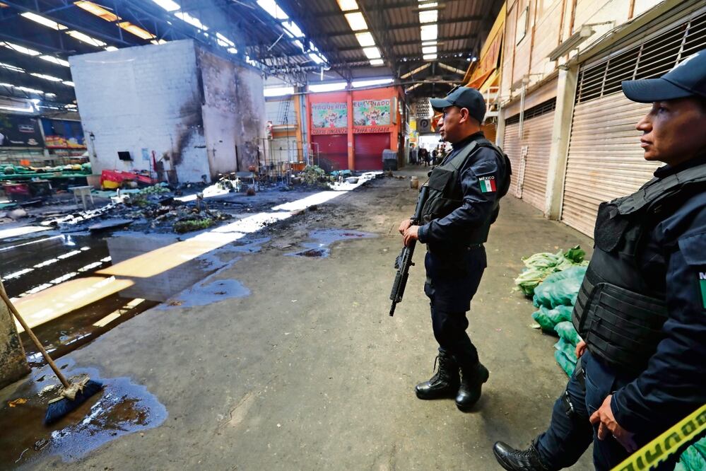 Elementos de la policía estatal resguardan la zona del incendio en el que murieron nueve personas. Autoridades de la mesa directiva de la Central de Abasto de Toluca niegan que opere algún grupo delictivo. Foto: Jorge Alvarado / EL UNIVERSAL