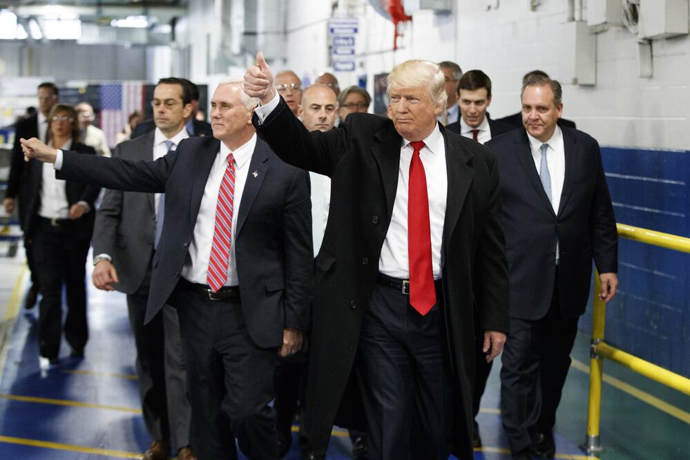 In this Thursday, Dec. 1, 2016 file photo, President-elect Donald Trump and Vice President-elect Mike Pence wave as they visit to Carrier factory, in Indianapolis, Ind. (AP Photo/Evan Vucci, File)