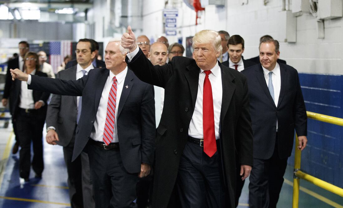 In this Thursday, Dec. 1, 2016 file photo, President-elect Donald Trump and Vice President-elect Mike Pence wave as they visit to Carrier factory, in Indianapolis, Ind. (AP Photo/Evan Vucci, File)