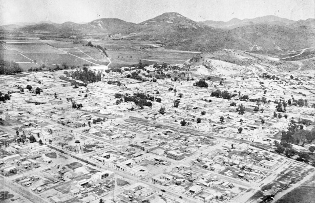 Una toma aérea en la que se aprecia el centro de la población de la entonces Delegación Guadalupe Hidalgo en el año de 1930; un año después cambiaría de nombre a Villa Gustavo A. Madero. En el fondo, los cerros de Cuautepec. Imagen: Col. Villasana-Torres