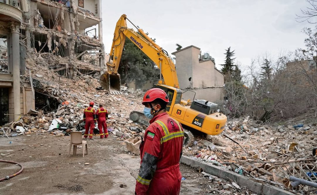 Personal de la Media Luna Roja Iraní al retirar los escombros de un edificio alcanzado por un ataque conjunto entre EU e Israel en Teherán. Foto: Vahid Salemi / AP