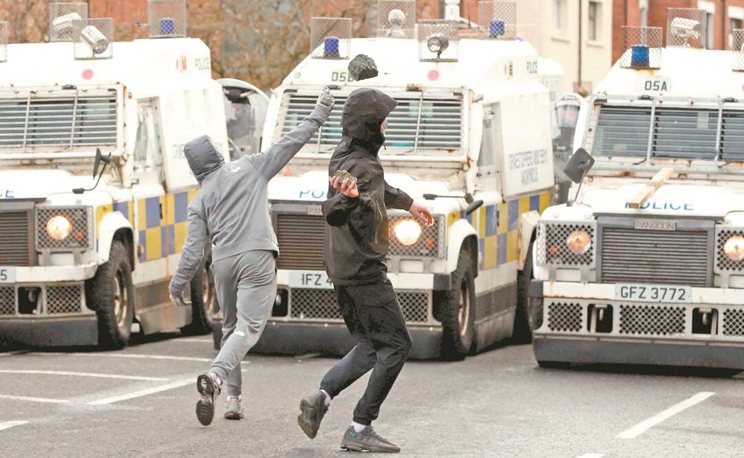 Jóvenes unionistas ayer al atacar a policías en Belfast. Se han reportado disturbios en los últimos días. Foto: Paul Faith/ AFP.