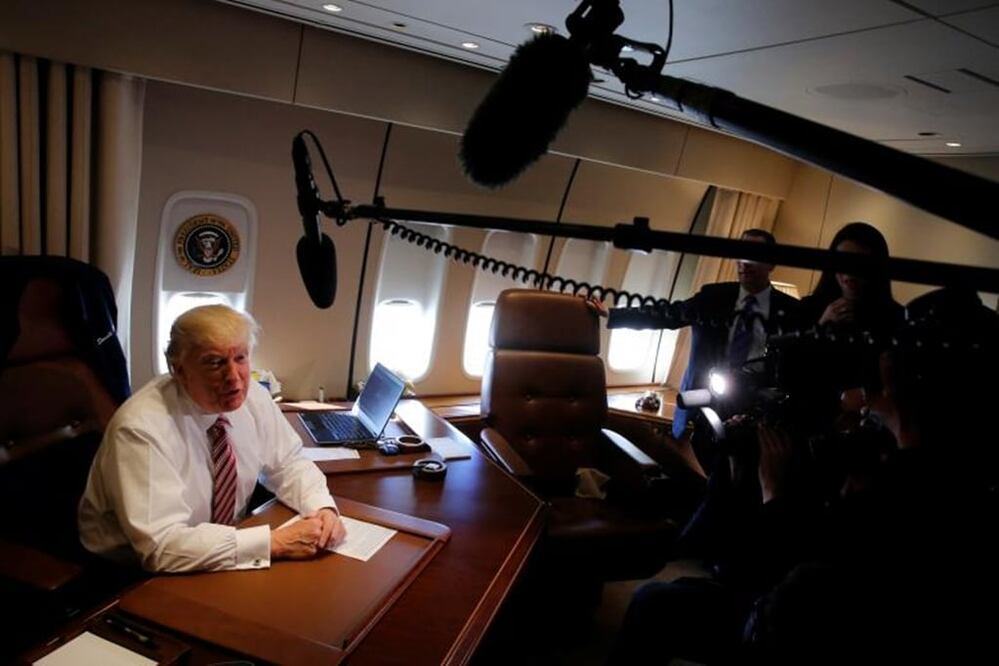 President Donald Trump speaks briefly to reporters as he arrives aboard Air Force One at Joint Base Andrews, Maryland, January 26, 2017. REUTERS/Jonathan Ernst