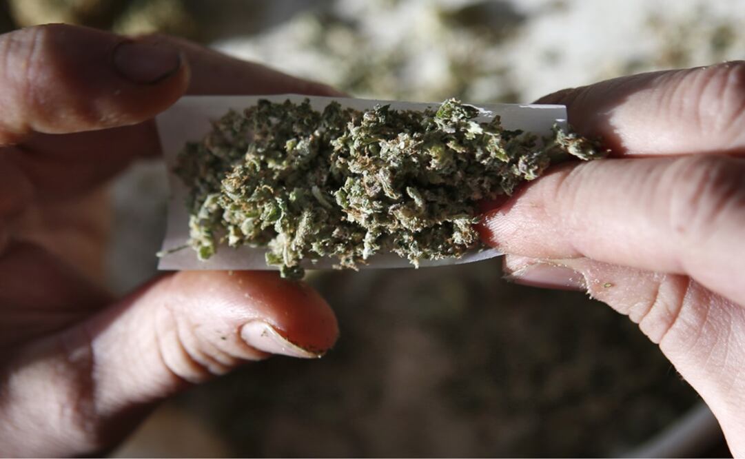 A person prepares a marijuana joint -Photo: Robert F. Bukaty/AP
