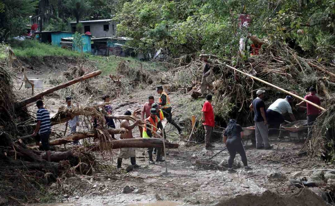 Personas remueven escombros por inundaciones en la aldea Rio Abajo este viernes, en Tegucigalpa (Honduras). Foto: EFE