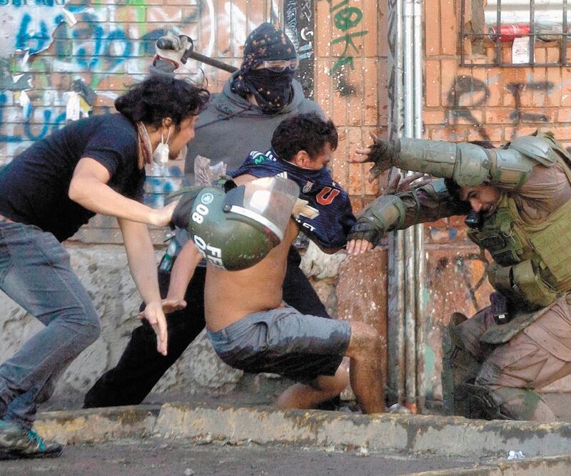 Violencia. Enfrentamientos entre chilenos y los carabineros, ayer en Santiago. Foto/CLAUDIO REYES. AFP