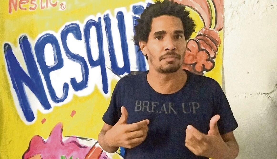 El artista y disidente cubano Luis Manuel Otero Alcántara, en abril de 2021, frente a una de sus pinturas en La Habana. Foto: AFP