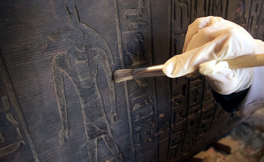 Un experto en antigüedades egipcias limpia un sarcófago de hace 3 mil años. Foto: Archivo