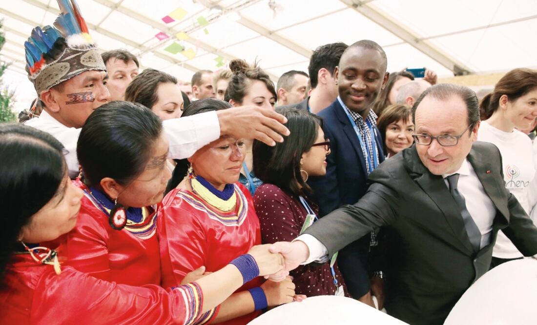 El presidente francés, François Hollande, saluda a indígenas ecuatorianos en el área Generaciones Climáticas, durante la jornada de ayer de la COP21, en Le Bourget, al norte de París