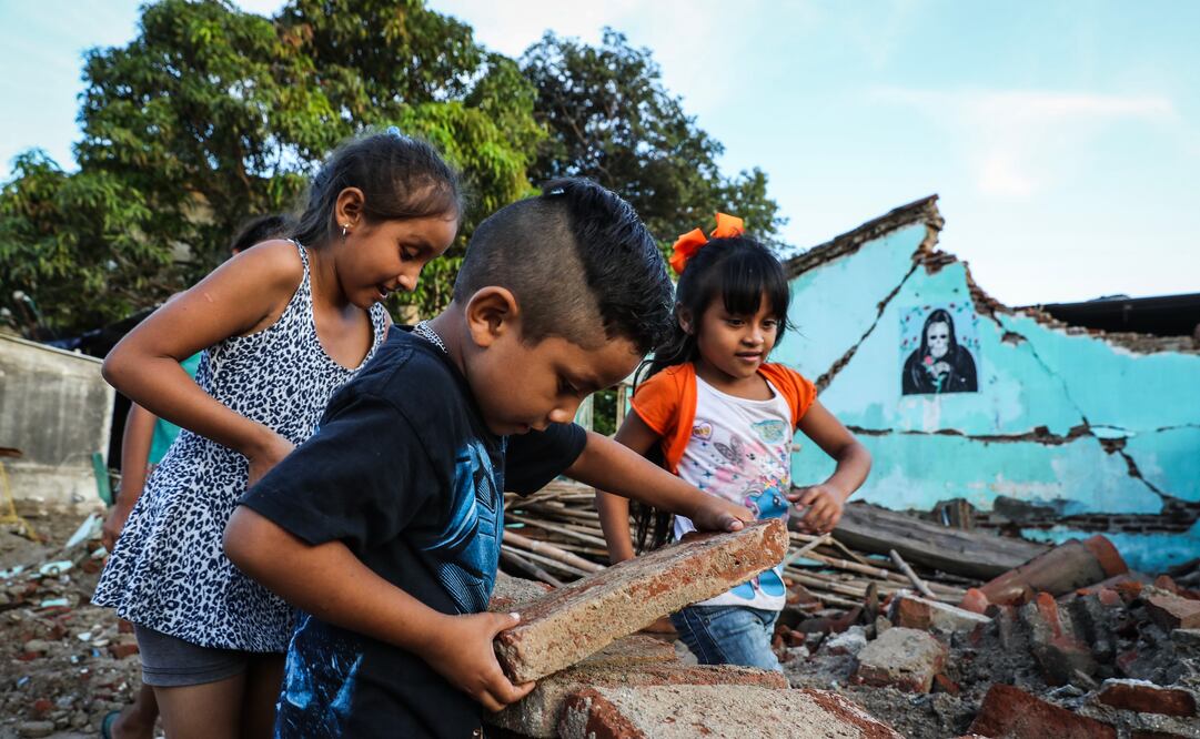 Entre juego, niños como Juan, Teresa y Lupita acarrean escombros para ayudar a sus padres a levantar su comunidad devastada por el sismo del 7 de septiembre . (Foto: JUAN CARLOS REYES)