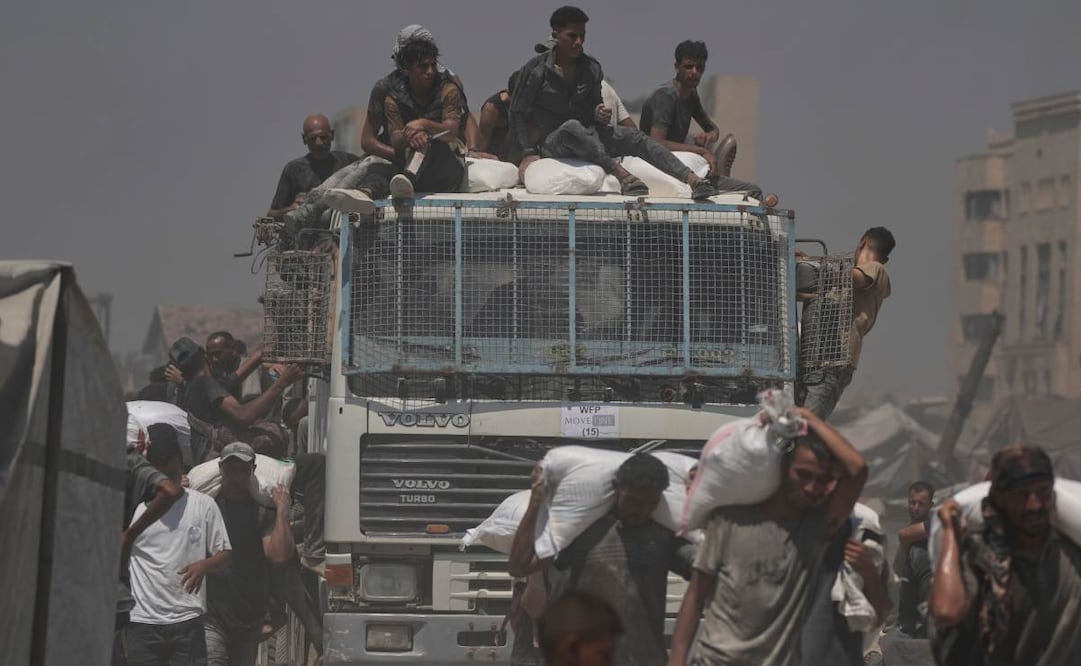 Palestinos cargan sacos de harina descargados de un convoy de ayuda humanitaria que llegó a la ciudad de Gaza desde el norte de la Franja de Gaza, el domingo 27 de julio de 2025. Foto: AP