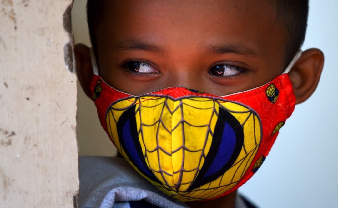 A boy wears a Spiderman-themed face mask, amid concerns over a spread of COVID-19 – Photo: Tang Chhin Sothy/AFP