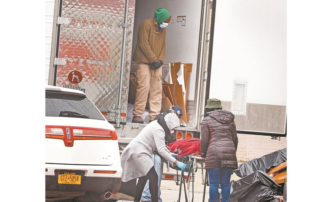 Un cuerpo es removido de un tráiler afuera de una funeraria en Brooklyn, Nueva York. El gobierno estatal y la fiscalía de Brooklyn investigan a la empresa, que poseía estos camiones y debía ocuparse de los cadáveres. Foto: JUSTIN LANE. EFE