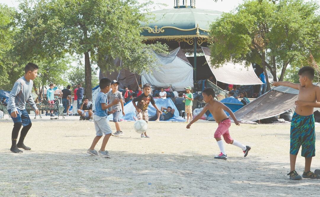 Niños migrantes juegan futbol en el parque Plaza de la República, donde está el campamento que sus padres han improvisado en el centro de Reynosa. Foto: Sandra Tovar