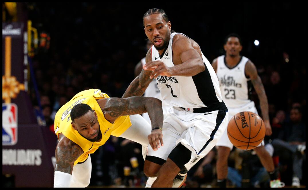 Kawhi Leonard le gana un balón a LeBron James en la victoria de Clippers sobre Lakers (AP)