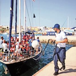 Barco con migrantes llega a isla italiana y desafía al gobierno