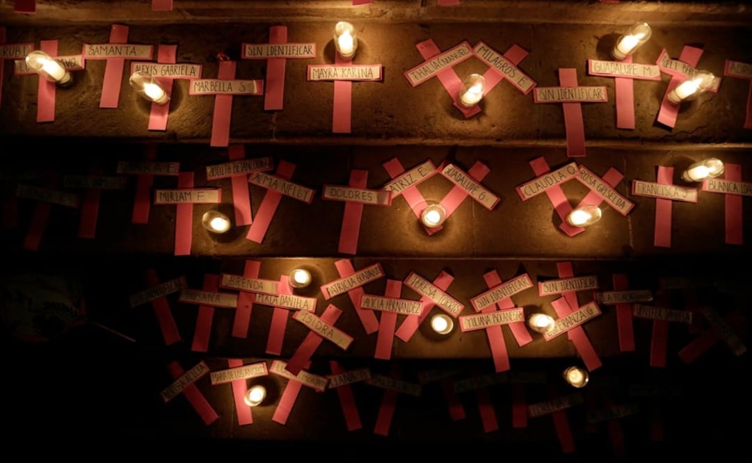 Pink crosses bearing the names of female victims are seen with candles during a rally against gender violence in Mexico – Photo: Daniel Becerril/REUTERS