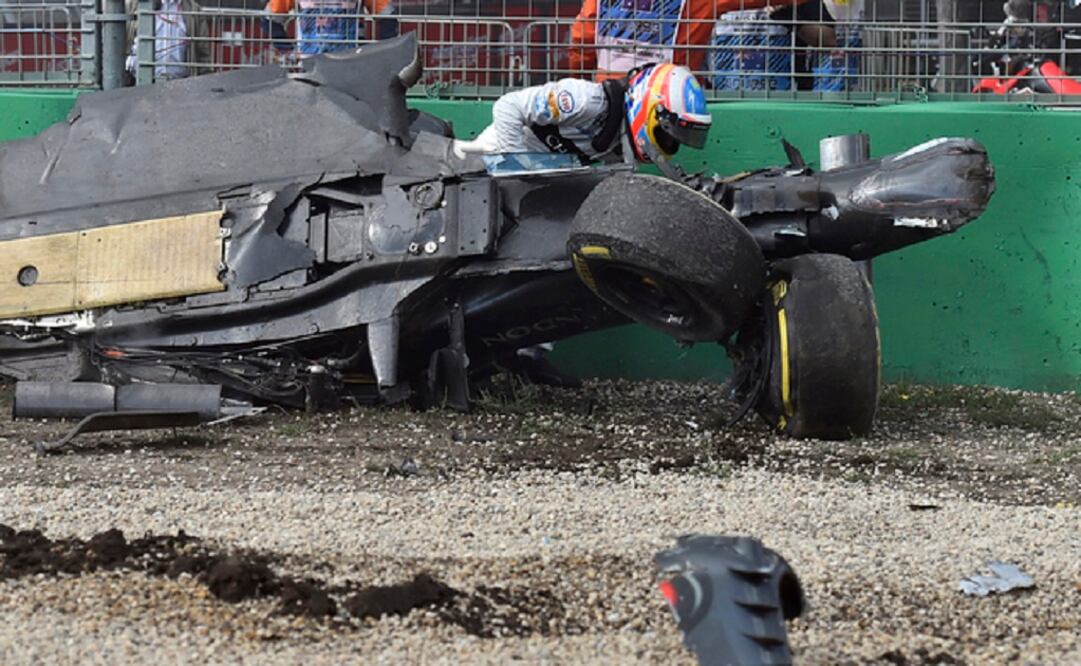So violent was the force of the crash that fans were left fearing the worst before Alonso crawled out of the cockpit and limped away. (Photo: AP) 