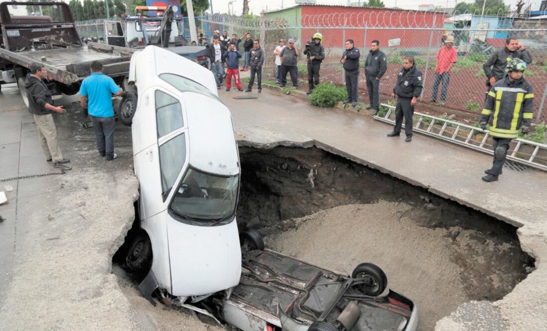 Los conductores de las dos unidades accidentadas en la madrugada del viernes no lograron ver el acordonamiento de la zona, de modo que uno de los autos quedó dentro de la oquedad. Foto: HUGO GARCÍA. EL UNIVERSAL