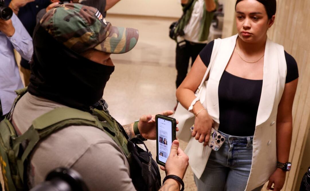 Un agente federal usa información en su teléfono mientras detiene a una mujer fuera de las audiencias de la corte de inmigración en el Edificio Federal Jacob K. Javits en Nueva York, EU, el 14 de julio de 2025. Foto: EFE