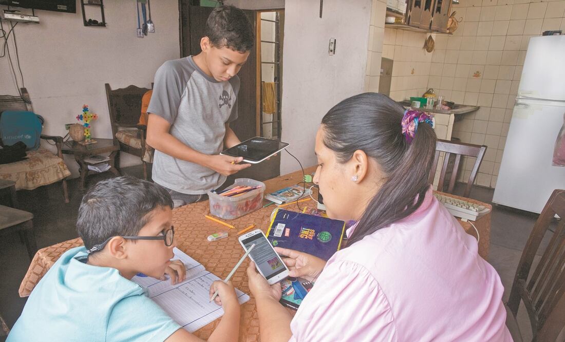 Una mamá ayuda a sus hijos con las tareas, en Caracas, Venezuela. Foto: ARIANA CUBILLOS. AP