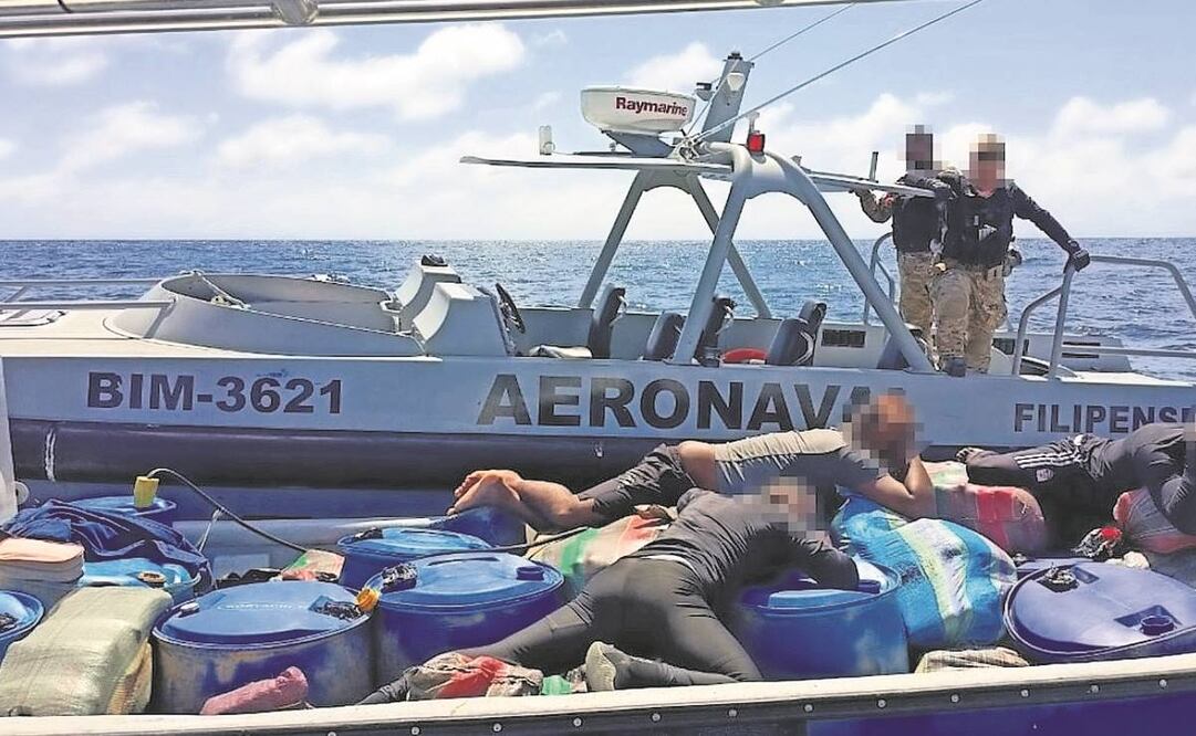 Oficiales costarricenses vigilan a narcotraficantes colombianos detenidos el 18 de diciembre en una lancha con cocaína en aguas de Costa Rica, en el mar Caribe.