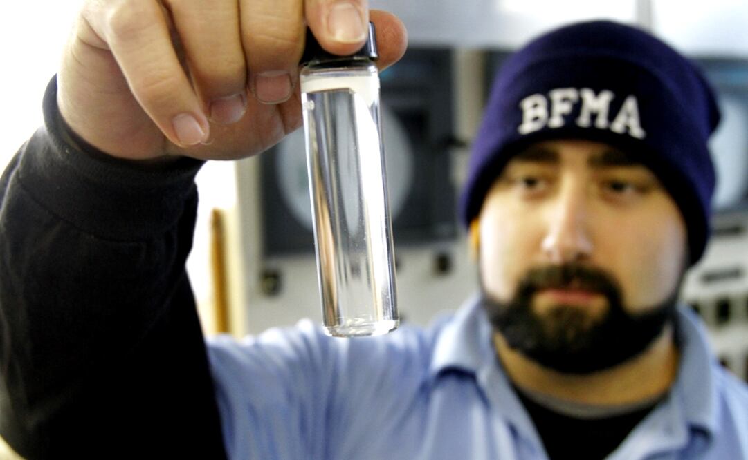 Water plant operator Torrey Jones checks the clarity of a sample of treated water at the Beaver Falls Municipal Authority water treatment plant in Beaver Falls, Pa. - Photo: Keith Srakocic/AP