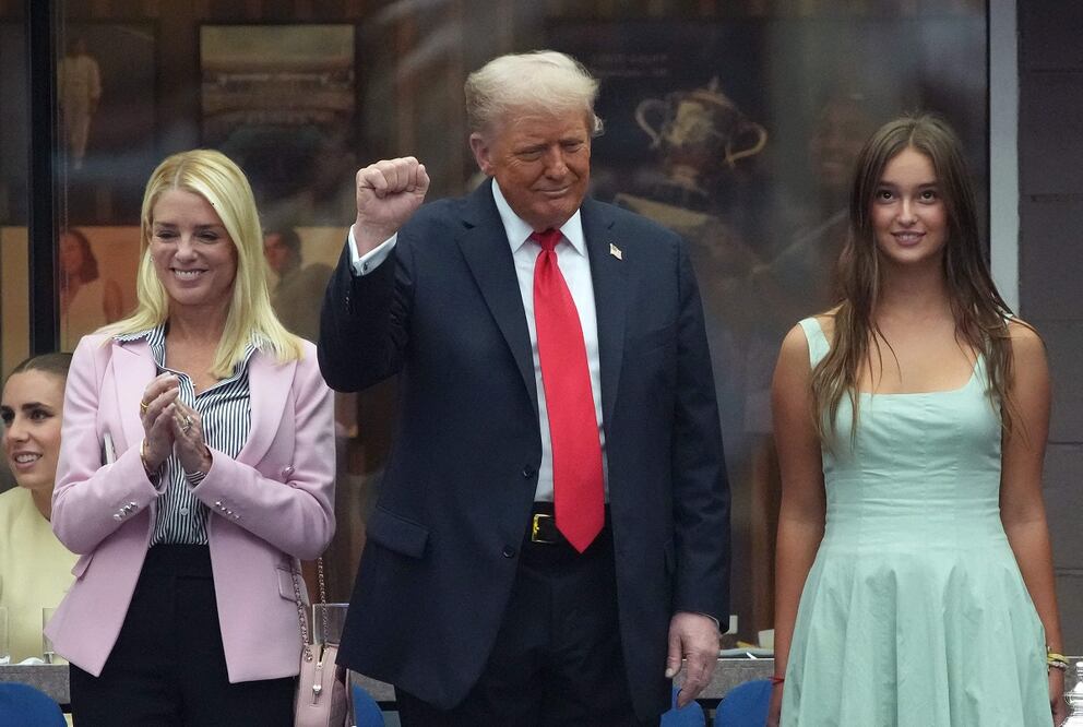 El presidente estadounidense, Donald Trump, saluda con el puño, acompañado de la fiscal general Pam Bondi (izq.) y su nieta, Arabella Kushner, hija de Ivanka, durante la final del Abierto masculino de Tenis, en Nueva York. FOTO: AFP