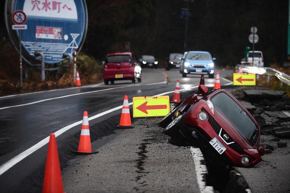 Un automóvil permanece atrapado en la antigua acera en la ciudad de Anamizu, prefectura de Ishikawa, el 6 de enero de 2024, después de que un gran terremoto de magnitud 7.5 sacudiera la región de Noto el día de Año Nuevo. Foto: AFP