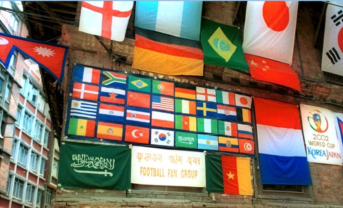 Old house in Katmandu, Nepal, decorated with flags of different countries participating in the 2002 World Cup  - Photo: Binod Joshi/AP