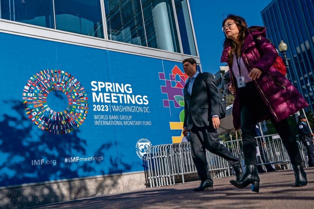 Peatones pasan frente a la sede del Fondo Monetario Internacional, que inició sus reuniones de primavera en Washington.