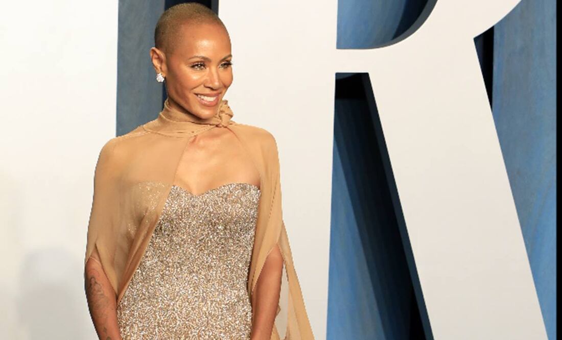 Jada, sentada, se avienta hacia adelante riendo y rápidamente recupera la compostura. Foto: EFE