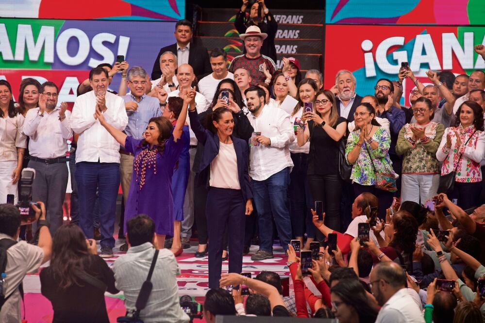 Clara Brugada y Claudia Sheinbaum levantan la mano para celebrar su triunfo en las urnas, durante un evento de la jefa de Gobierno electa con simpatizantes en la Arena México. Foto: de YARETZY M. OSNAYA. EL UNIVERSAL