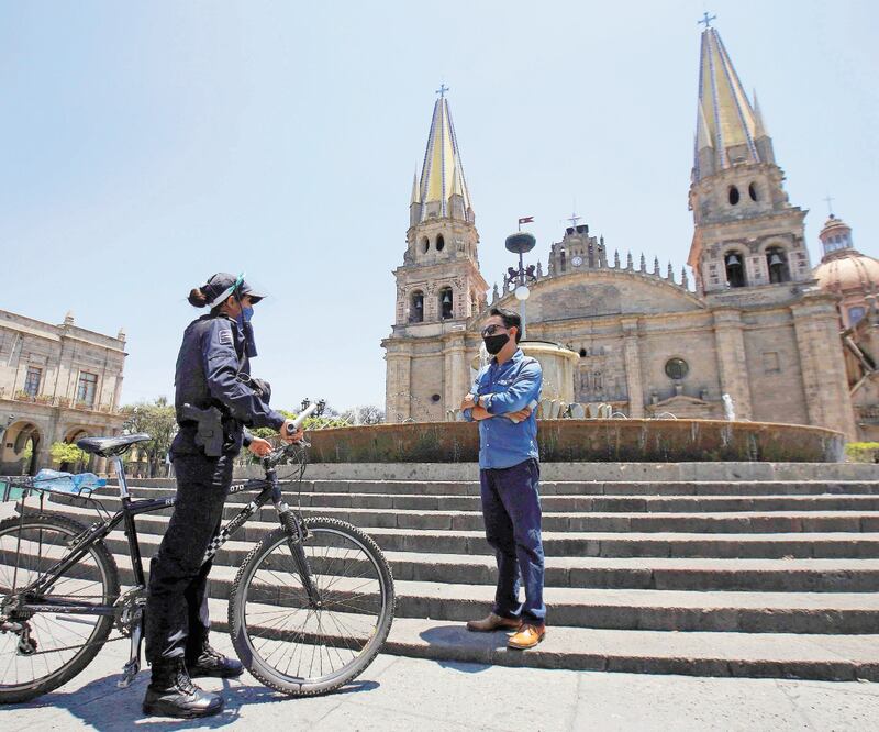 Policías interrogan a ciudadanos sobre lo que hacen en las calles y les piden que vuelvan a su casa. De no acatar la orden, pueden amonestarlos. ULISES RUIZ. AFP