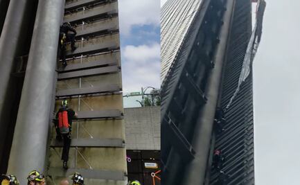 Durante desfile, retiran manta contra la militarización de Estela de Luz