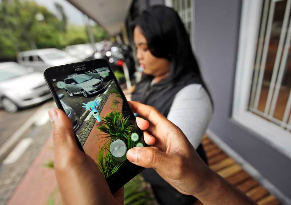 Unas personas juagan "Pokémon Go" en Yakarta, Indonesia. Indonesia prohibió jugar al popular juego de realidad aumentada en el palacio presidencial. (Foto AP/Achmad Ibrahim)