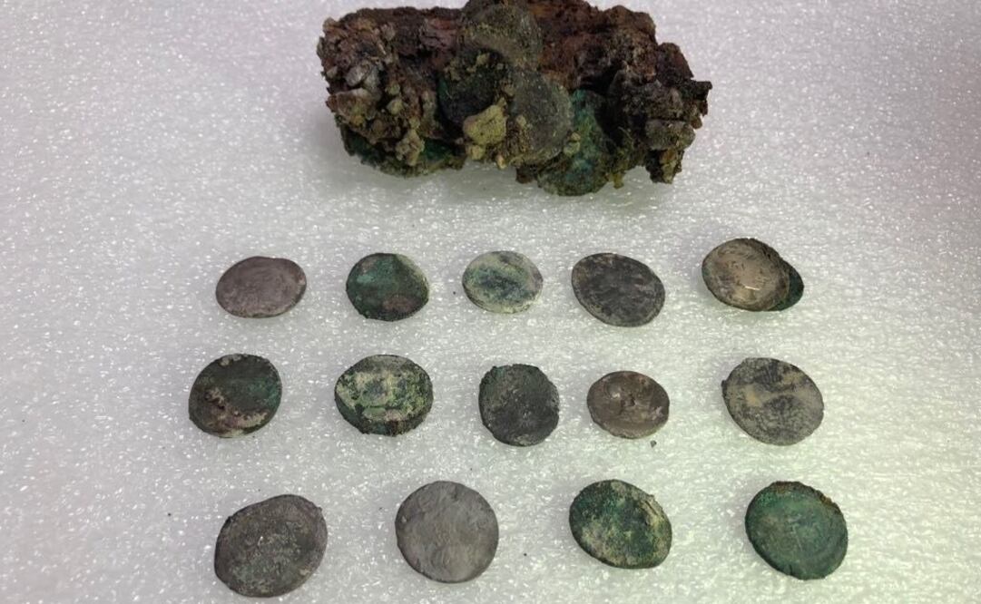 Monedas localizadas junto al esqueleto descubierto recientemente de un hombre con problemas de movilidad aplastado por una roca en Pompeya. Foto: EFE