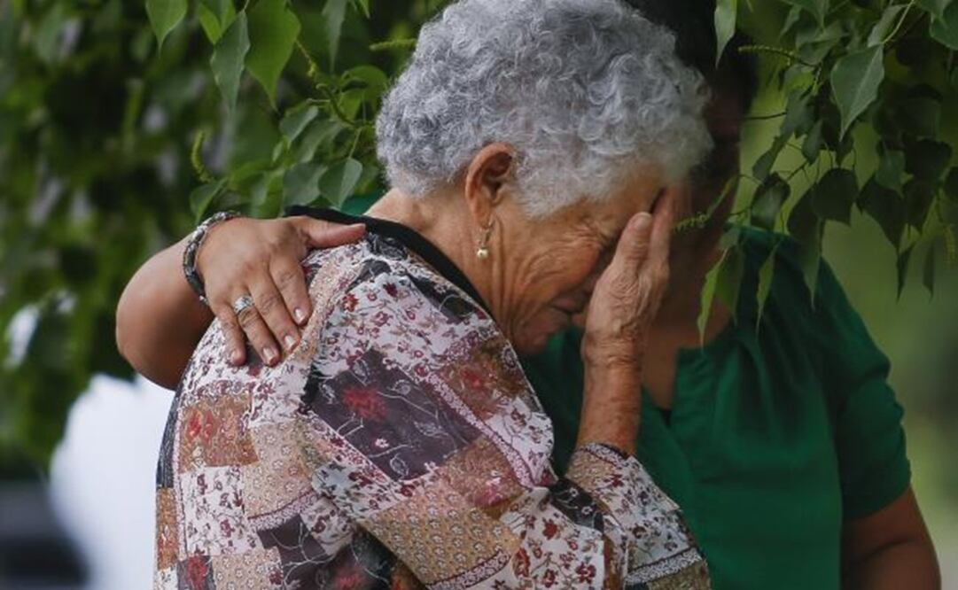 María Cristina Sepulveda, right, comforts Lesa Mendes, the grandmother of 11-year-old Josué Flores, at a makeshift memorial for Flores. (Picture: AP)