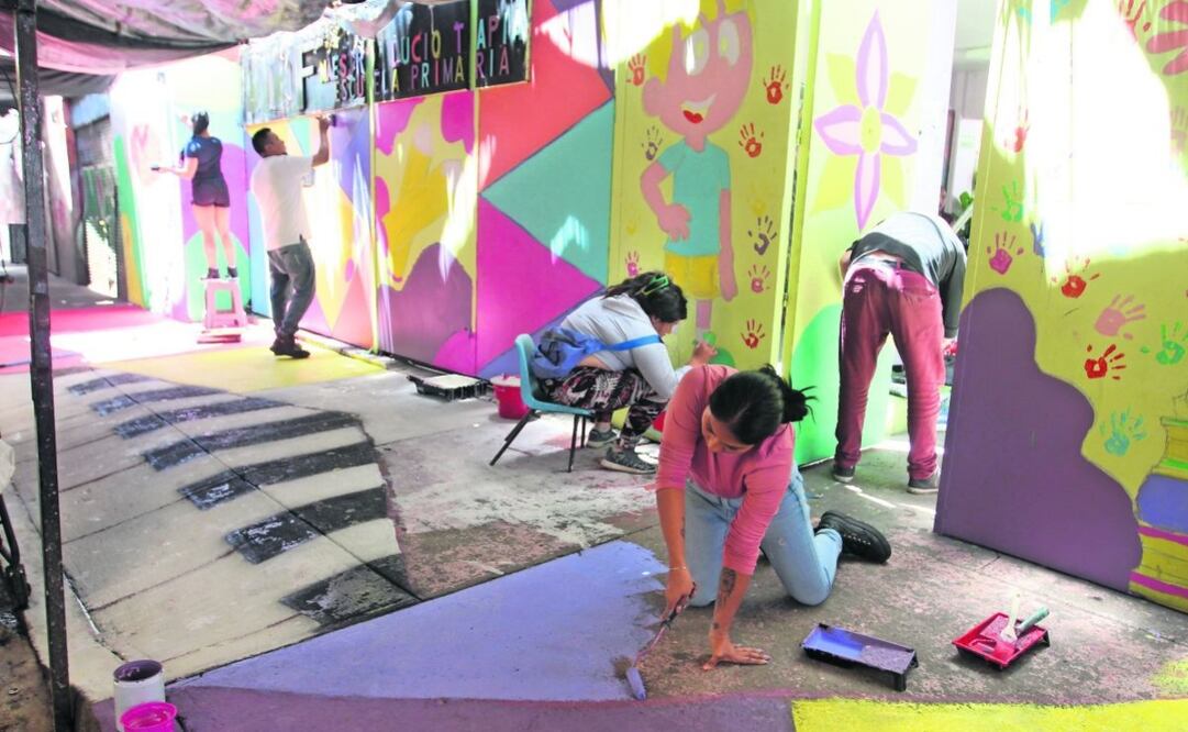Padres de familia de alumnos de la primaria Lucio Tapia se encargaron de pintar la barda, con material proporcionado por Red Viral y Barriópolis. Foto: Francisco Rodríguez | El Universal