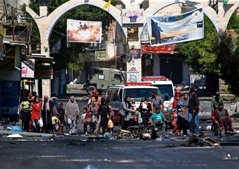 Miembros de la Sociedad de la Media Luna Roja Palestina ayudan a los refugiados a evacuar el campamento de Yenín. Foto: Alaa Badarne/EFE