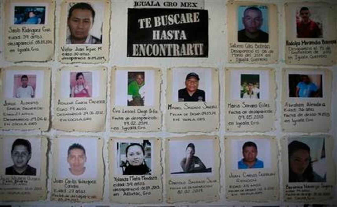 Snapshots with brief descriptions of missing people are tacked to a board in the San Gerardo Catholic Parish in Iguala, Mexico. (Photo: AP)