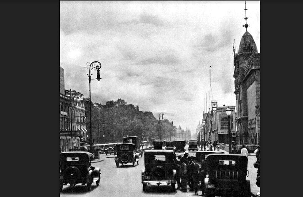 El tráfico citadino de la avenida Juárez, a la altura del cruce con Balderas, hacia los años veinte. Del lado derecho sobresale el singular edificio del Pabellón Español; del lado izquierdo se aprecian los frondosos árboles de la Alameda Central. Imagen: Col. Villasana-Torres