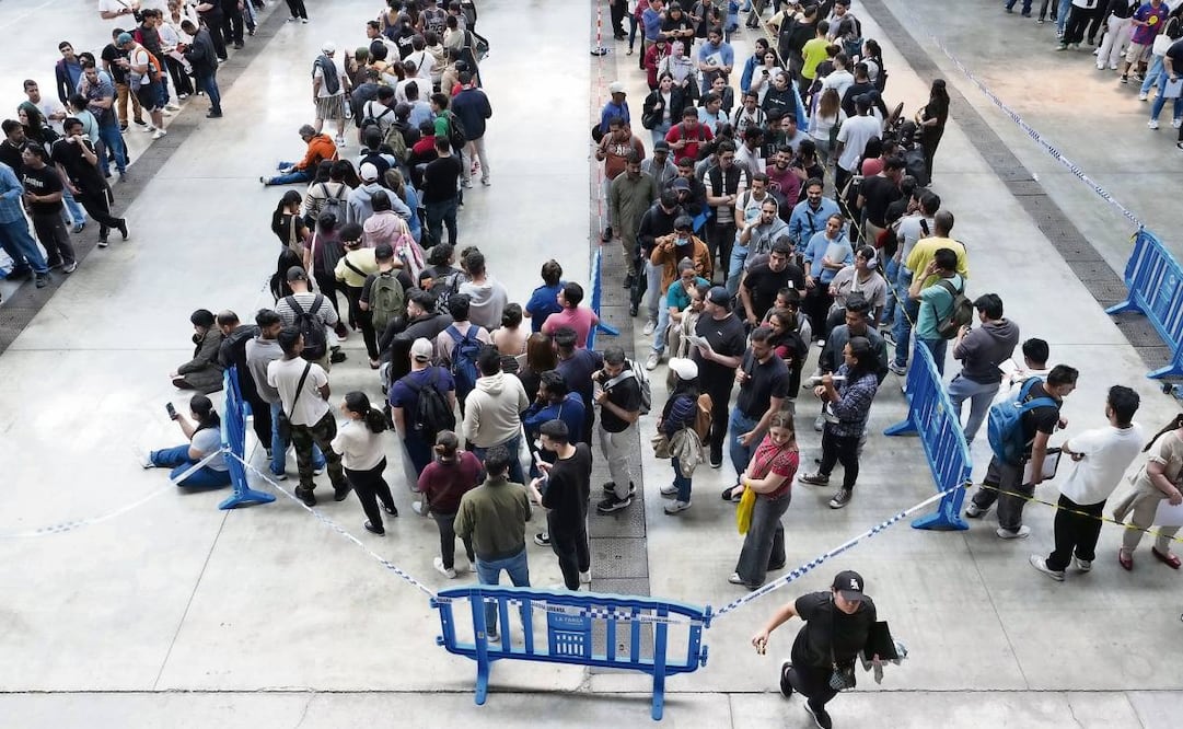 Cientos de personas esperan en el recinto ferial de La Farga, en Barcelona, para regularizar su situación.  Foto: Enric Fontcuberta / EFE