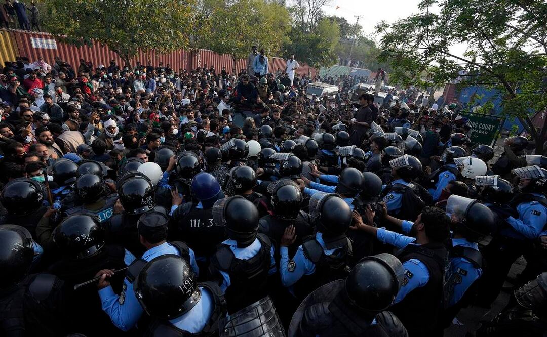 Los partidarios del exprimer ministro Imran Khan, contra la policía para dar paso a un vehículo, en Islamabad. Foto: AP