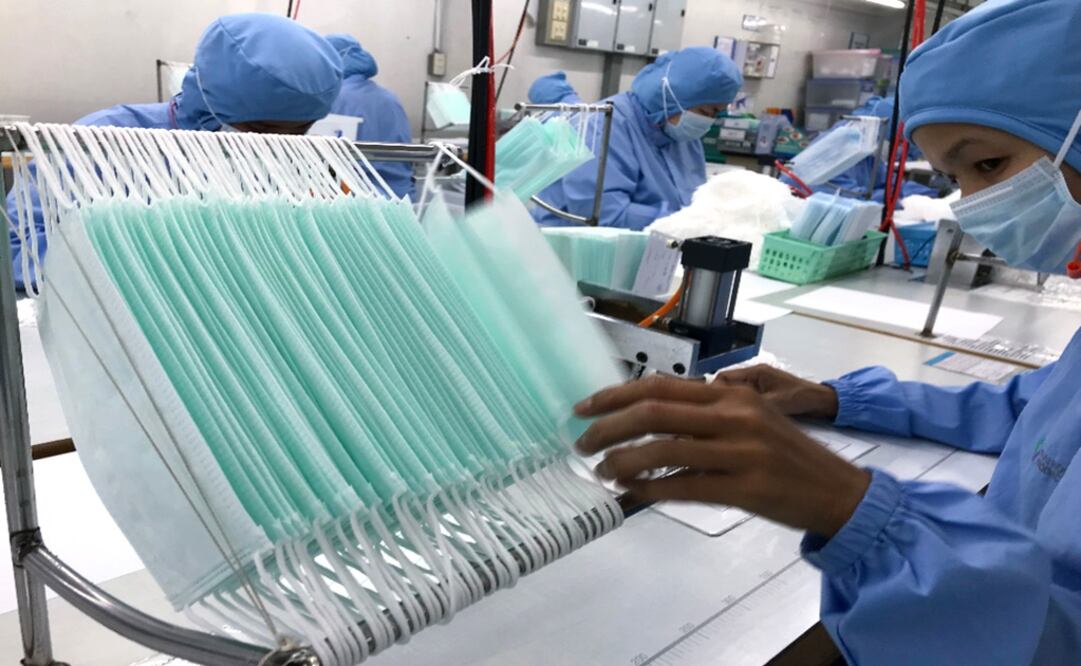 Workers produce masks at the Thai Hospital Product Company Ltd. factory in Bangkok – Photo: Jonathan Klein/AFP