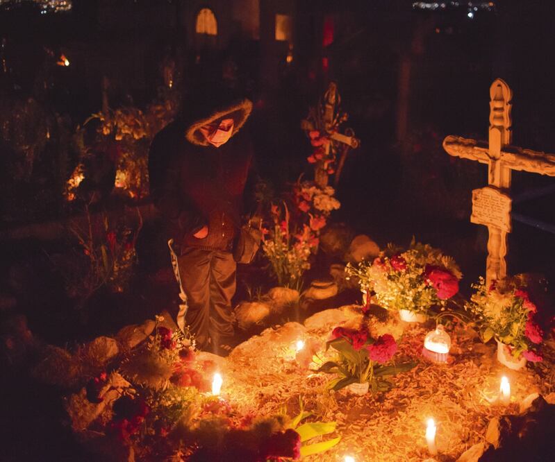 En el Día de Muertos, cientos de familias recordaron a sus difuntos, algunos fallecidos recientemente por la pandemia en el país. Imagen de habitantes de San Isidro Buensuceso, en Tlaxcala, quienes pasaron la noche en el panteón, como es su tradición. CO