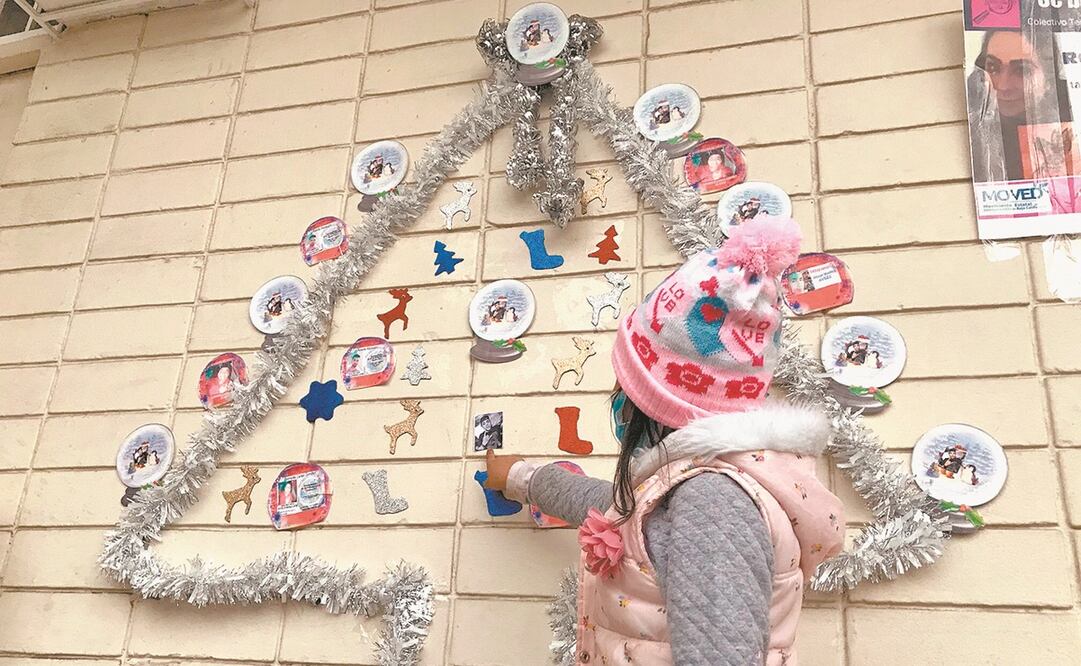 Los hijos de Mónica le ayudaron a colocar un árbol de Navidad en la pared del Capea. Foto: Gabriela Martínez. EL UNIVERSAL