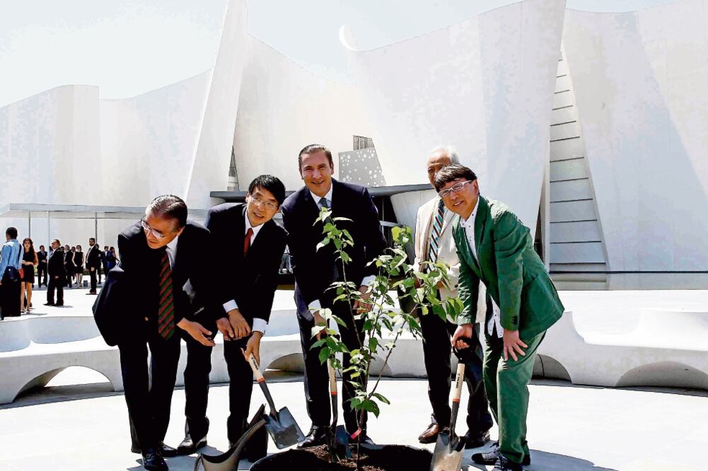 El gobernador Rafael Moreno Valle (al centro), el arquitecto Toyo Ito (verde) y autoridades japonesas plantaron tres árboles de cerezos fuera del recinto (Especial)