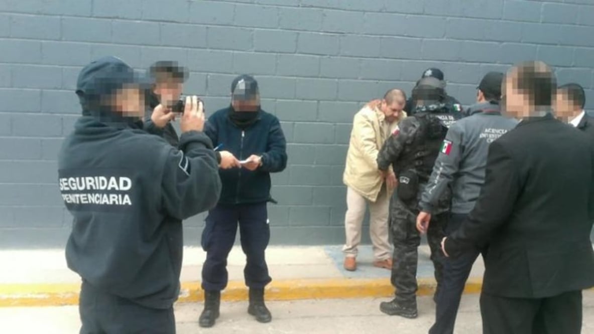 Mexico's top drug lord Joaquin ''El Chapo'' Guzman is escorted by police officers in Ciudad Juarez, Mexico, as he is extradited to New York in this handout image made available January 19, 2017. PGR - Mexico's Attorney General's Office/Handout via REUTERS